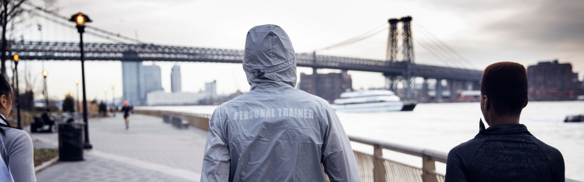 Personal trainer and colleague walking in New York Bridge